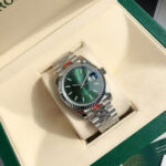 The log is engraved with silver and green strips imitating mechanical strips